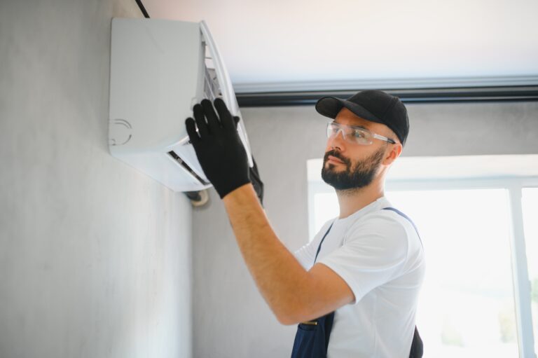 Repairman fix air conditioning systems, Male technicians service for repair and maintenance of air conditioners, Air conditioning technicians install new air conditioners in homes.